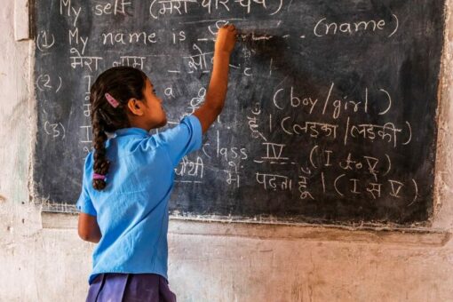 Girl writes on the blackboard